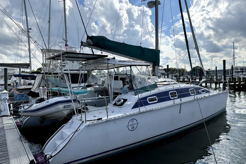 Serenity Yacht Photos Pics 2003 PDQ 36 Capella catamaran docked at marina under cloudy sky.