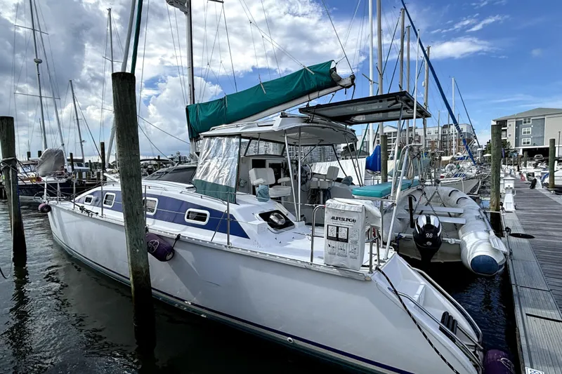 Serenity Yacht Photos Pics 2003 PDQ 36 Capella catamaran docked at marina under blue sky.