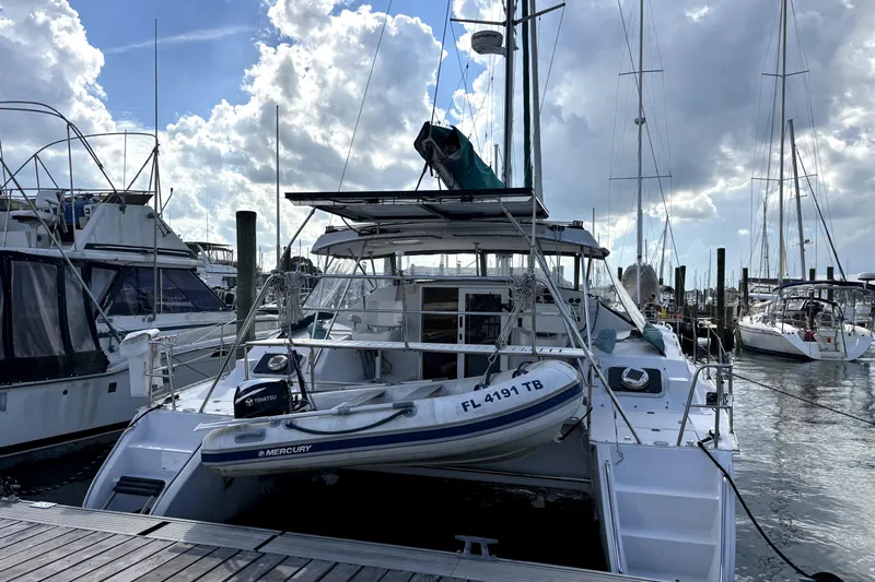 Serenity Yacht Photos Pics 2003 PDQ 36 Capella catamaran docked at marina under cloudy sky.