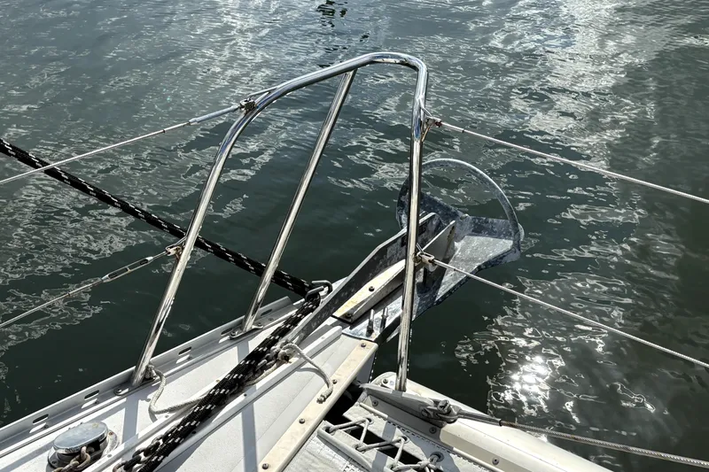 Serenity Yacht Photos Pics Bow of 2003 PDQ 36 Capella sailboat with anchor over water.