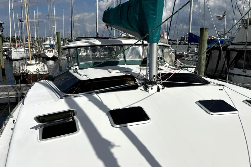 Serenity Yacht Photos Pics 2003 PDQ 36 Capella catamaran docked at marina, featuring open hatches and green sail cover.