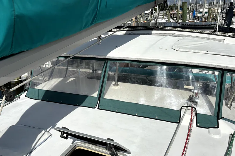 Serenity Yacht Photos Pics 2003 PDQ 36 Capella catamaran with green canopy, docked at marina.