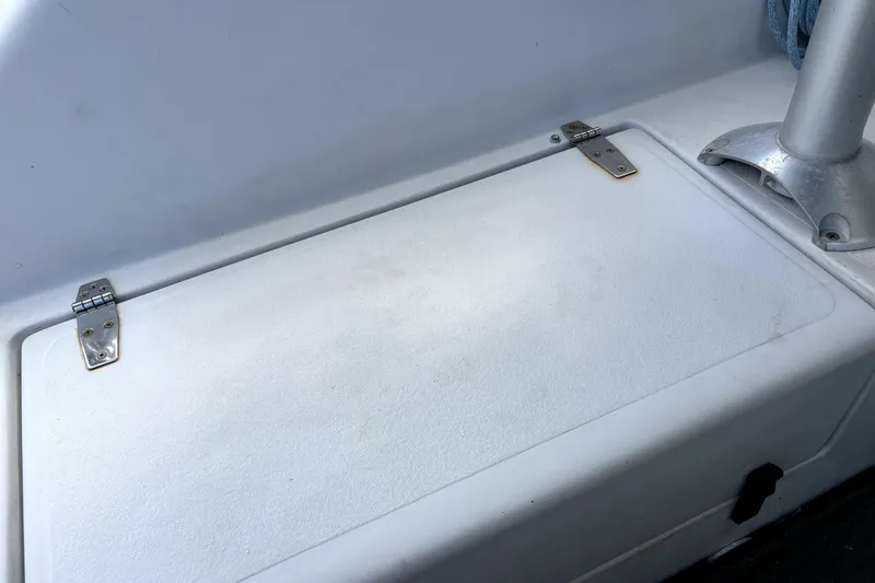 Serenity Yacht Photos Pics Storage compartment on a 2003 PDQ 36 Capella boat, featuring metal hinges.