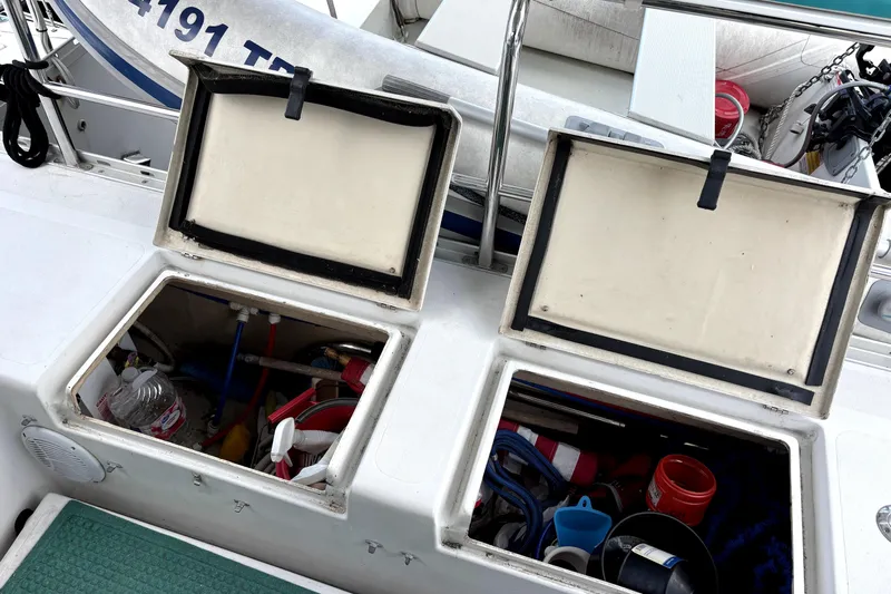 Serenity Yacht Photos Pics Open storage compartments on a 2003 PDQ 36 Capella boat deck, revealing various equipment.