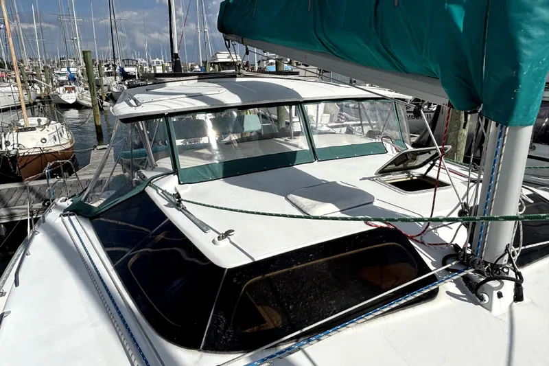 Serenity Yacht Photos Pics 2003 PDQ 36 Capella catamaran docked at a marina, featuring green sail cover.