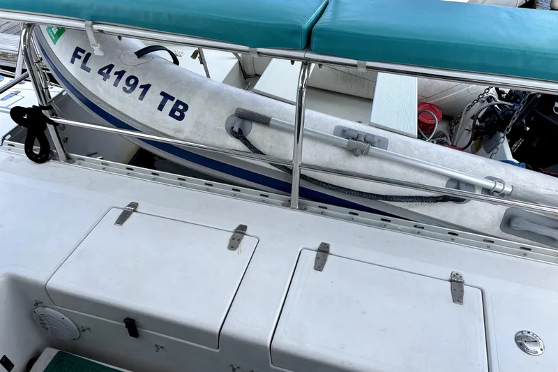 Serenity Yacht Photos Pics 2003 PDQ 36 Capella boat with dinghy, registration FL 4191 TB, docked with teal seating.