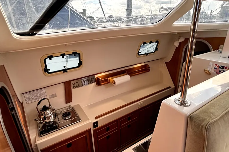 Serenity Yacht Photos Pics Interior of 2003 PDQ 36 Capella yacht with compact kitchen and stove.