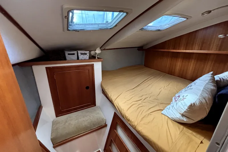 Serenity Yacht Photos Pics Cozy cabin interior of 2003 PDQ 36 Capella with bed and storage.