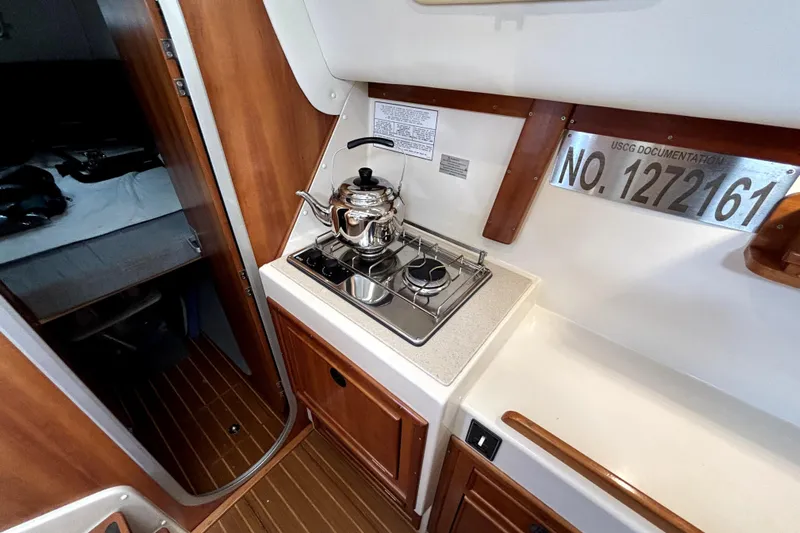 Serenity Yacht Photos Pics Compact galley in 2003 PDQ 36 Capella boat with stove and kettle.