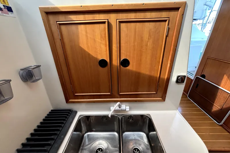 Serenity Yacht Photos Pics Wooden cabinet and sink in 2003 PDQ 36 Capella boat interior.