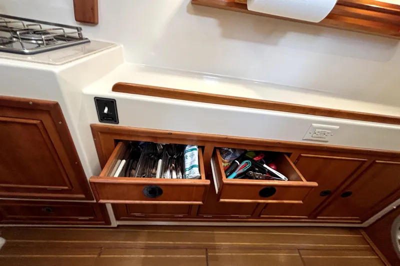 Serenity Yacht Photos Pics 2003 PDQ 36 Capella kitchen with open wooden drawers and stove.