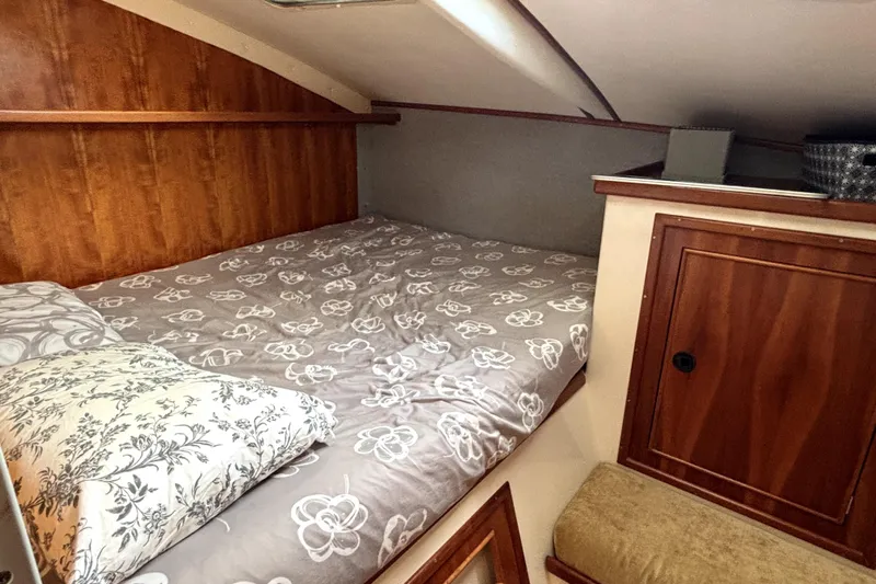 Serenity Yacht Photos Pics Cozy cabin interior of 2003 PDQ 36 Capella with floral bedding and wooden accents.