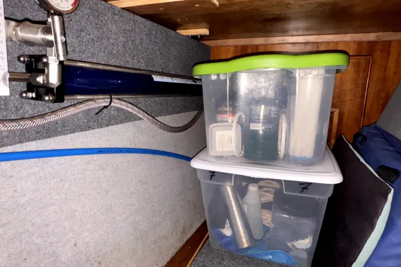 Serenity Yacht Photos Pics Storage area in a 2003 PDQ 36 Capella with organized plastic containers and equipment.