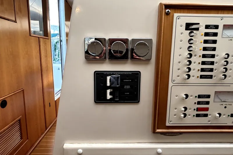 Serenity Yacht Photos Pics Control panel of a 2003 PDQ 36 Capella boat, featuring switches and dials.