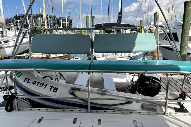 Serenity Yacht Photos Pics 2003 PDQ 36 Capella catamaran docked, featuring seating and a Tohatsu outboard motor.