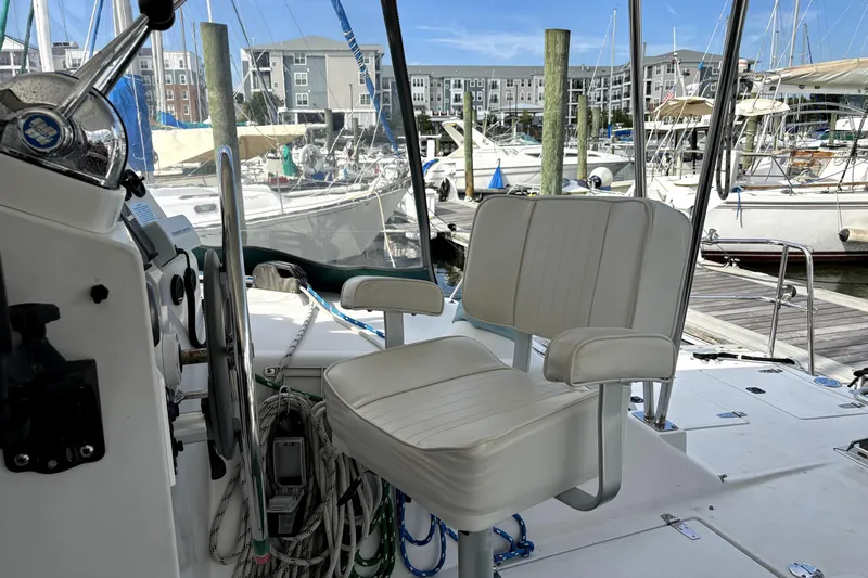 Serenity Yacht Photos Pics 2003 PDQ 36 Capella boat cockpit with white captain's chair, marina view in background.