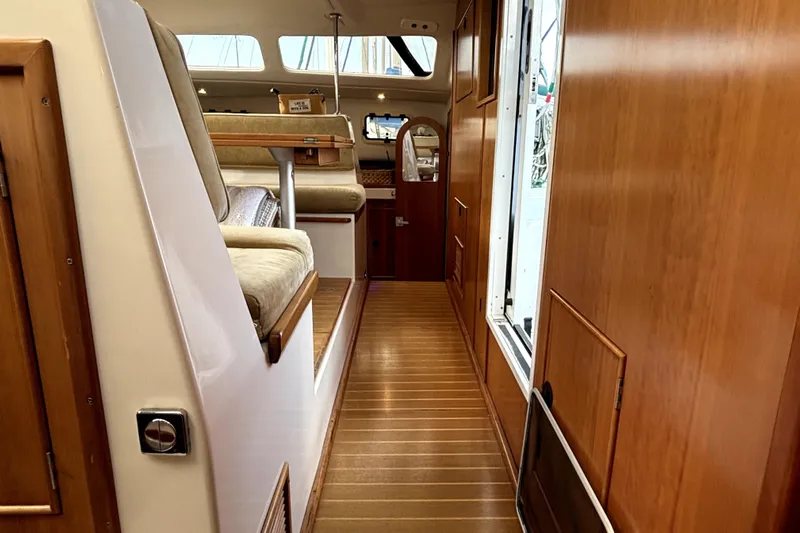 Serenity Yacht Photos Pics Interior of 2003 PDQ 36 Capella yacht with wooden finishes and seating area.