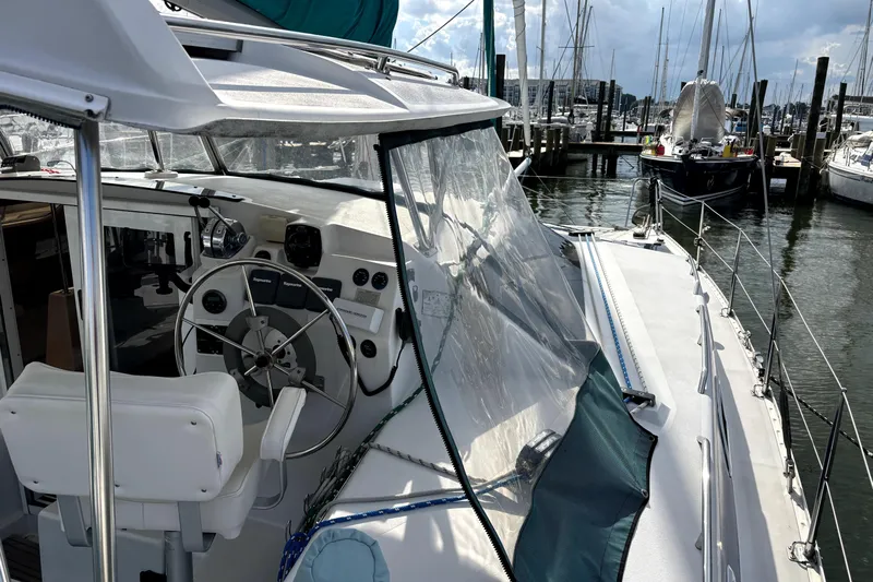 Serenity Yacht Photos Pics 2003 PDQ 36 Capella sailboat docked at marina, featuring cockpit and steering wheel.