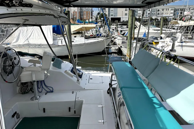 Serenity Yacht Photos Pics 2003 PDQ 36 Capella catamaran interior at marina, featuring helm and seating area.