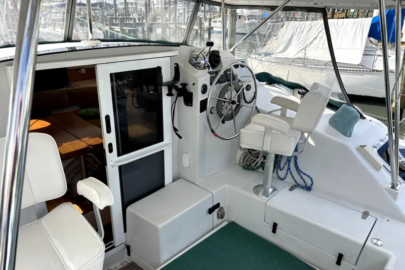 Serenity Yacht Photos Pics Interior view of 2003 PDQ 36 Capella boat cockpit with steering wheel and seating.
