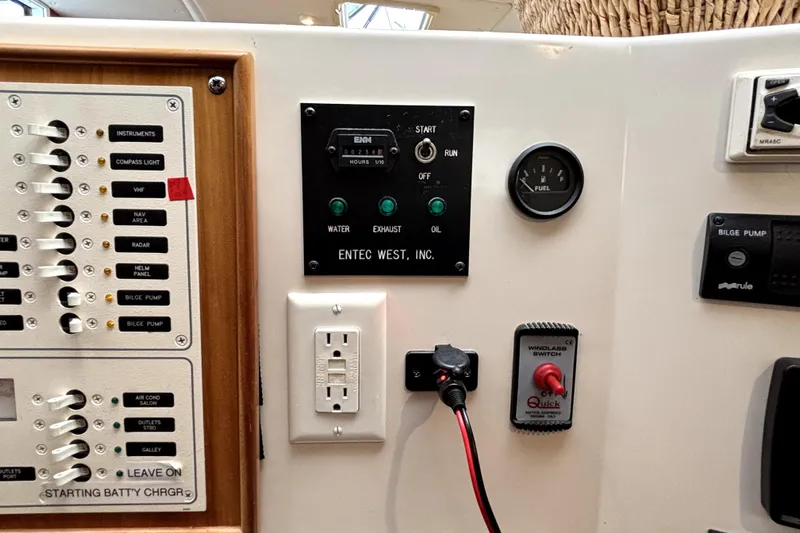 Serenity Yacht Photos Pics Control panel of a 2003 PDQ 36 Capella boat with various switches and gauges.