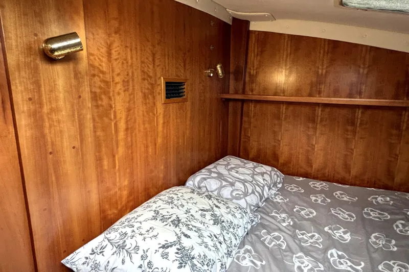 Serenity Yacht Photos Pics Cozy wooden cabin interior of 2003 PDQ 36 Capella with patterned bedding.
