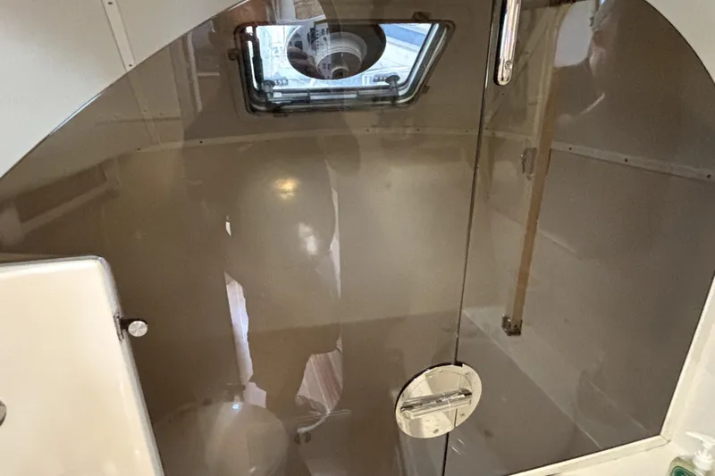 Serenity Yacht Photos Pics Interior of 2003 PDQ 36 Capella boat, featuring a compact bathroom with a porthole.