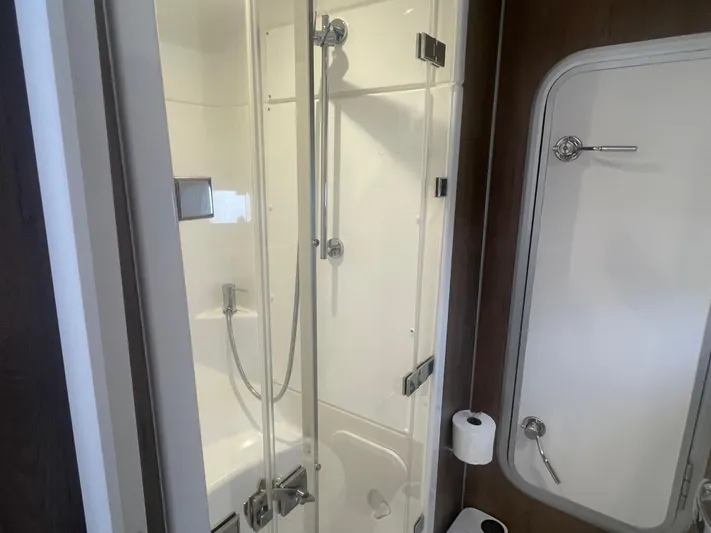  Yacht Photos Pics Compact modern shower in 2023 Bali 5.4 model, featuring glass doors and sleek fixtures.