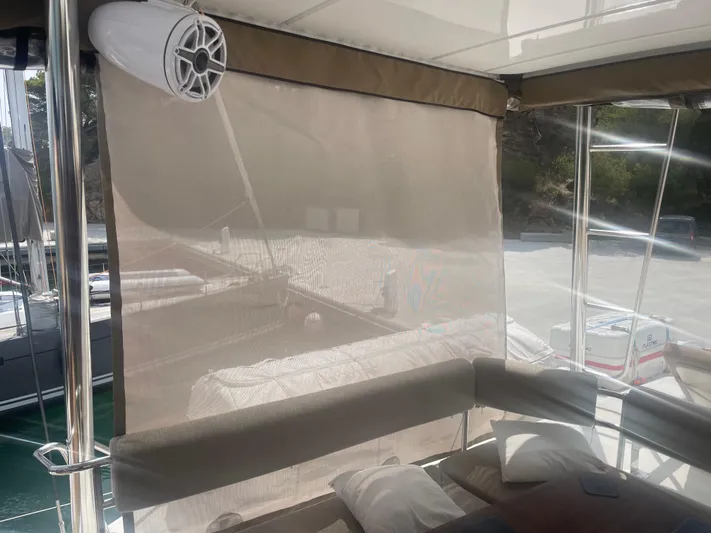  Yacht Photos Pics Interior of a 2023 Bali 5.4 yacht with shaded seating area and speaker.