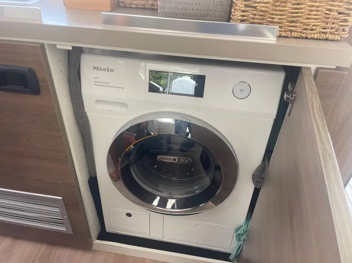  Yacht Photos Pics Compact Miele washer-dryer in a Bali 5.4, 2023 model, integrated into cabinetry.
