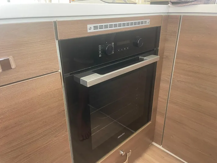  Yacht Photos Pics Modern Bali 5.4 oven, 2023 model, integrated in wooden kitchen cabinetry.