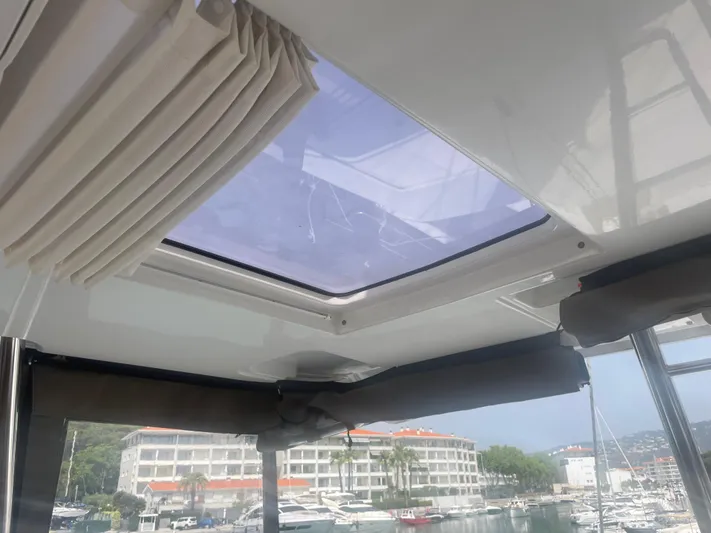  Yacht Photos Pics Interior view of 2023 Bali 5.4 yacht with skylight and marina backdrop.
