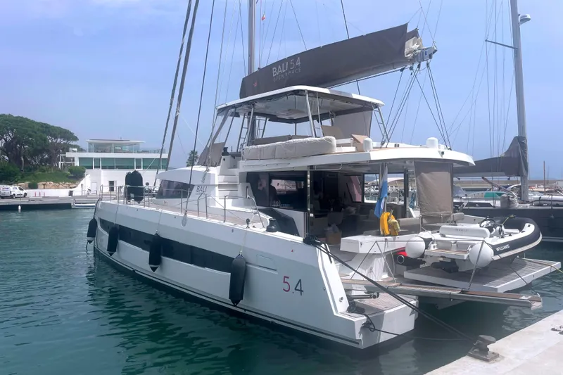  Yacht Photos Pics Luxury Bali 5.4 catamaran docked at marina, 2023 model, featuring spacious deck and modern design.