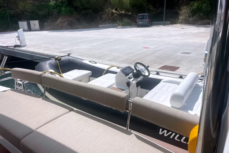  Yacht Photos Pics Modern Bali 5.4 boat docked, featuring sleek seating and steering console, 2023 model.