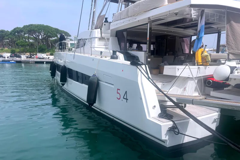  Yacht Photos Pics 2023 Bali 5.4 yacht docked at marina, featuring spacious deck and modern design.