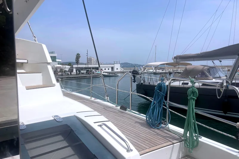  Yacht Photos Pics Modern Bali 5.4 yacht docked at marina, showcasing sleek design and spacious deck.