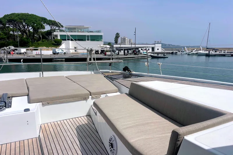  Yacht Photos Pics Luxurious Bali 5.4 yacht deck with seating, docked at a serene marina, 2023 model.