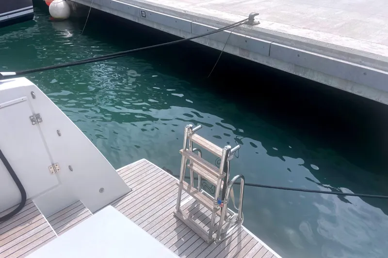  Yacht Photos Pics Docked Bali 5.4 yacht with ladder, 2023 model, at marina.