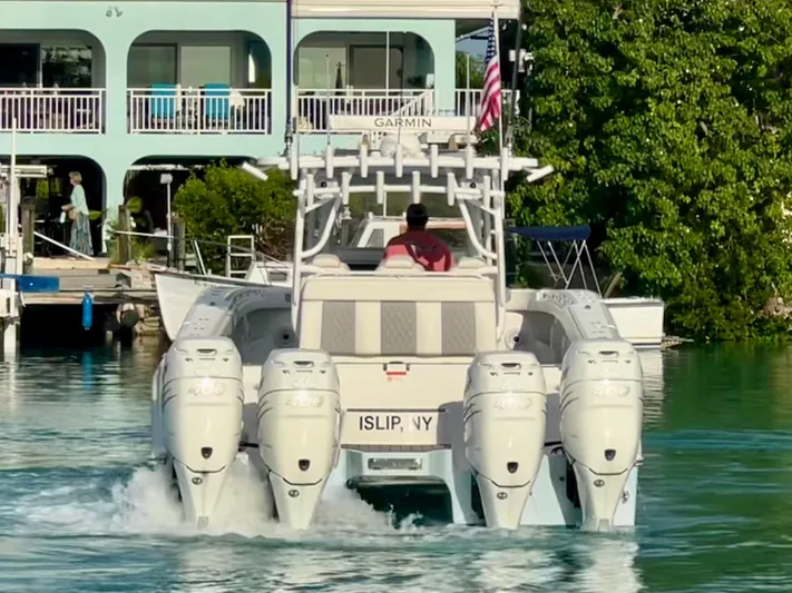 Lia Rose Yacht Photos Pics Invincible 46 Catamaran 2022 cruising on water near waterfront homes.