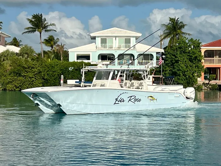 Lia Rose Yacht Photos Pics Invincible 46 Catamaran 2022 cruising near waterfront homes with palm trees.