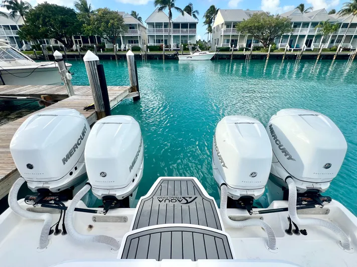 Lia Rose Yacht Photos Pics Invincible 46 Catamaran 2022 with four Mercury engines docked in turquoise marina.