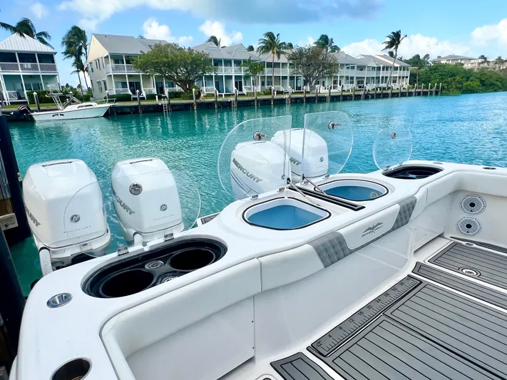 Lia Rose Yacht Photos Pics 2022 Invincible 46 Catamaran with powerful engines docked by waterfront homes.