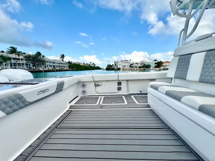 Lia Rose Yacht Photos Pics Invincible 46 Catamaran 2022, spacious deck with seating, scenic waterfront view.