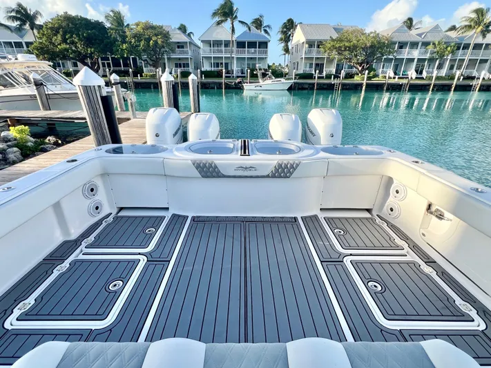 Lia Rose Yacht Photos Pics Invincible 46 Catamaran 2022 docked, showcasing spacious deck and serene waterfront view.