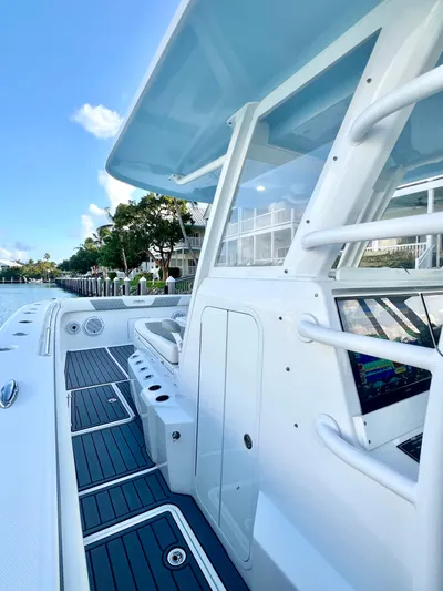 Lia Rose Yacht Photos Pics 2022 Invincible 46 Catamaran with sleek design and modern features docked by waterfront homes.