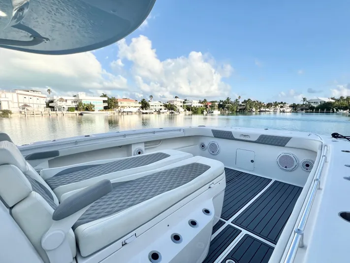 Lia Rose Yacht Photos Pics Invincible 46 Catamaran 2022, luxury seating, scenic waterfront view, clear skies.