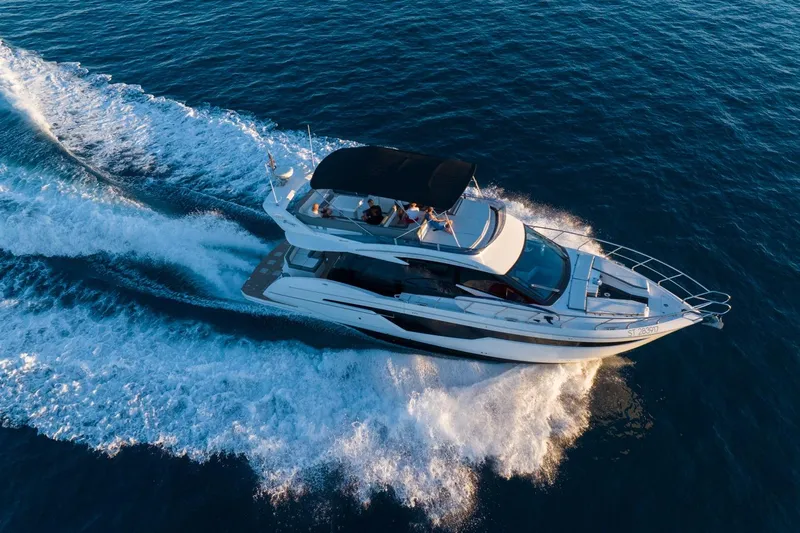  Yacht Photos Pics 2023 Galeon 500 Fly yacht cruising on open water, aerial view.