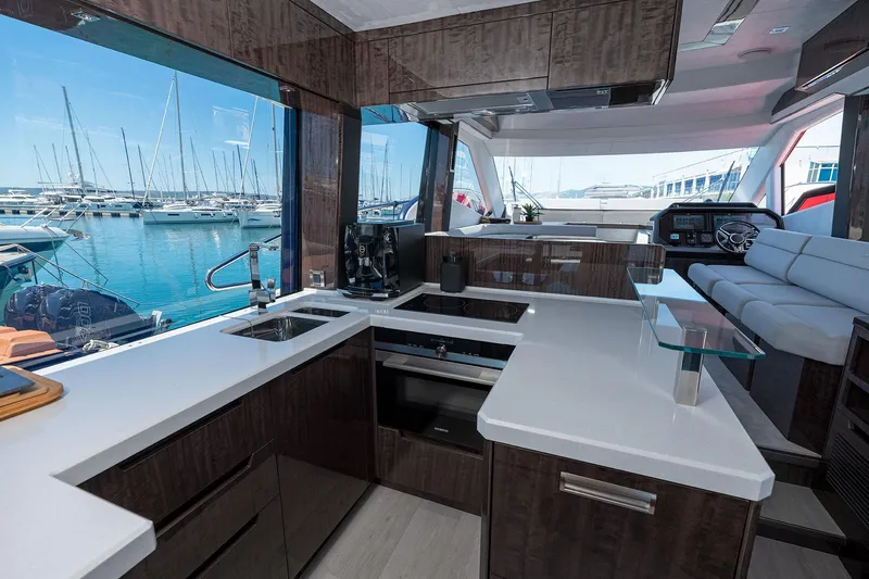  Yacht Photos Pics Luxurious interior of 2023 Galeon 500 Fly yacht with modern kitchen and marina view.