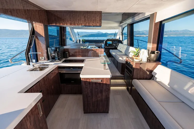  Yacht Photos Pics Luxurious interior of 2023 Galeon 500 Fly yacht with modern kitchen and seating area.