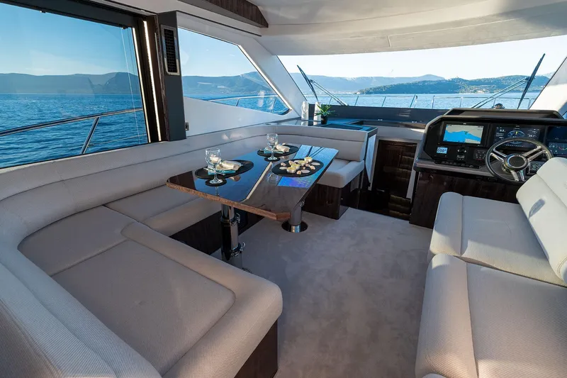  Yacht Photos Pics Luxurious interior of 2023 Galeon 500 Fly yacht with elegant seating and scenic ocean view.